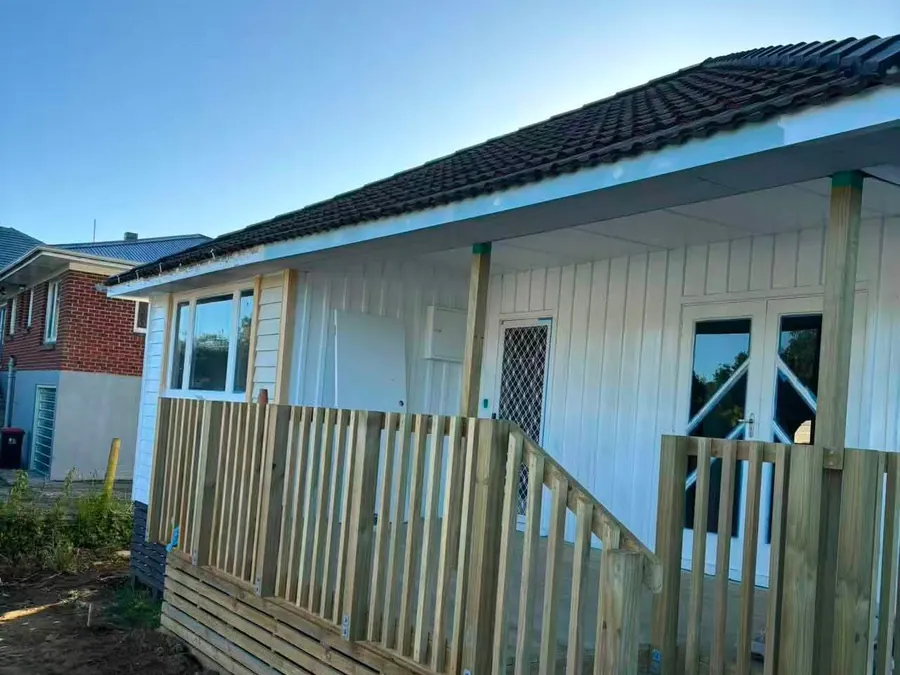 New timber fence and deck rail along the side of a weatherboard house