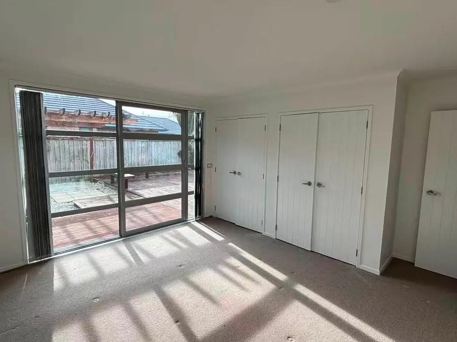 Freshly painted room with new wardrobe doors and full-height window