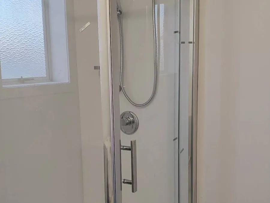 New shower enclosure installed in a light-filled bathroom