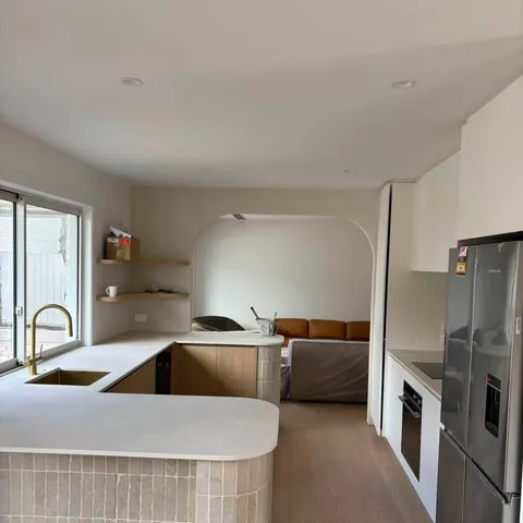 Curved kitchen island with new benchtop and appliances