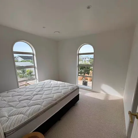 Bedroom with arched windows and new carpet